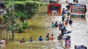 People wade through a waterlogged street at Parel area, after heavy monsoon rain, in Mumbai(PTI Photo) People wade through a waterlogged street at Parel area, after heavy monsoon rain, in Mumbai(PTI Photo)