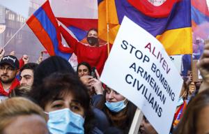 Protestors wave flags and hold signs outside of an EU summit meeting in Brussels to demonstrate in support of Armenia and against the war in the Nagorno-Karabakh region (AP Photo/Olivier Matthys) Protestors wave flags and hold signs outside of an EU summit meeting in Brussels to demonstrate in support of Armenia and against the war in the Nagorno-Karabakh region (AP Photo/Olivier Matthys)