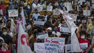 Protestors gather to raise their voices against the gang-rape and killing of the 19-year-old Dalit woman in Uttar Pradesh.(AP photo) Protestors gather to raise their voices against the gang-rape and killing of the 19-year-old Dalit woman in Uttar Pradesh.(AP photo)
