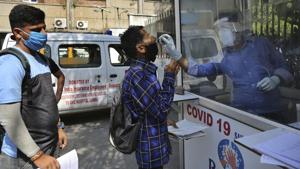 A health worker collects a man's swab sample to test for Covid-19 at a government hospital in Jammu on Thursday.(AP) A health worker collects a man's swab sample to test for Covid-19 at a government hospital in Jammu on Thursday.(AP)