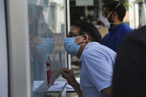 A man registers his name for Covid testing at a government hospital in Jammu on Thursday.(AP) A man registers his name for Covid testing at a government hospital in Jammu on Thursday.(AP)