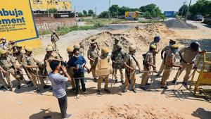 Policemen stand guard at the entrance to Hathras village in Uttar Pradesh on Friday.(HT Photos/Amal KS) Policemen stand guard at the entrance to Hathras village in Uttar Pradesh on Friday.(HT Photos/Amal KS)