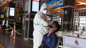 A health worker in a PPE kit collects a swab sample from an Indian railways employee for a rapid antigen Covid-19 test at New Delhi Railway Station.(HT PHOTO.) A health worker in a PPE kit collects a swab sample from an Indian railways employee for a rapid antigen Covid-19 test at New Delhi Railway Station.(HT PHOTO.)