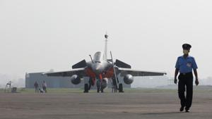 An Indian Air Force officer wearing a protective face mask walks in front of a Rafale fighter jet during its induction ceremony at an air force station in Ambala, India, September 10, 2020.(REUTERS) An Indian Air Force officer wearing a protective face mask walks in front of a Rafale fighter jet during its induction ceremony at an air force station in Ambala, India, September 10, 2020.(REUTERS)