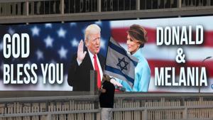 Backdropped by a billboard supporting President Donald Trump and first lady Melania Trump, a man wave the Israeli national flag on a bridge during a protest against Israel's Prime Minister Benjamin Netanyahu in Tel Aviv, Israel.(AP) Backdropped by a billboard supporting President Donald Trump and first lady Melania Trump, a man wave the Israeli national flag on a bridge during a protest against Israel's Prime Minister Benjamin Netanyahu in Tel Aviv, Israel.(AP)