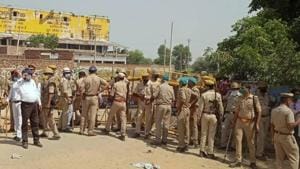 Police personnel stand guard at the entrance of the village in Hathras where the family of 19-year-old Dalit woman who was gang-raped two weeks ago resides.(PTI File Photo) Police personnel stand guard at the entrance of the village in Hathras where the family of 19-year-old Dalit woman who was gang-raped two weeks ago resides.(PTI File Photo)