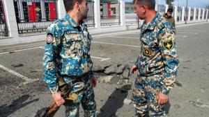 Servicemen of Armenia's Emergencies Ministry stand outside the ministry's building which is said was damaged by Azeri shelling in the breakaway Nagorny Karabakh's main city of Stepanakert on October 2, 2020, during the ongoing fighting between Armenia and Azerbaijan over the disputed region.(AFP) Servicemen of Armenia's Emergencies Ministry stand outside the ministry's building which is said was damaged by Azeri shelling in the breakaway Nagorny Karabakh's main city of Stepanakert on October 2, 2020, during the ongoing fighting between Armenia and Azerbaijan over the disputed region.(AFP)