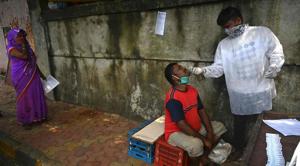 A health worker collects a swab sample during a medical screening for the Covid-19 Coronavirus, in Mumbai on October 3, 2020.(AFP photo) A health worker collects a swab sample during a medical screening for the Covid-19 Coronavirus, in Mumbai on October 3, 2020.(AFP photo)