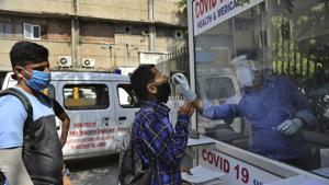 A health worker collects a man's swab sample at a government hospital in Jammu.(AP) A health worker collects a man's swab sample at a government hospital in Jammu.(AP)