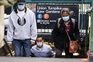 People wearing protective masks during the coronavirus pandemic exit the Kew Gardens subway station in the Queens borough of New York. New York governor Andrew Cuomo on Monday ordered schools in certain New York City neighborhoods closed within a day in an attempt to halt flare-ups of the coronavirus. (AP Photo/Frank Franklin II) People wearing protective masks during the coronavirus pandemic exit the Kew Gardens subway station in the Queens borough of New York. New York governor Andrew Cuomo on Monday ordered schools in certain New York City neighborhoods closed within a day in an attempt to halt flare-ups of the coronavirus. (AP Photo/Frank Franklin II)