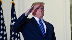 US President Donald Trump salutes as he poses on the Truman Balcony of the White House in Washington, DC after returning from the Walter Reed Medical Center in Bethesda, Maryland.(REUTERS) US President Donald Trump salutes as he poses on the Truman Balcony of the White House in Washington, DC after returning from the Walter Reed Medical Center in Bethesda, Maryland.(REUTERS)