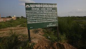 Jewar, India - September 29, 2019: A sign board is seen at the site for construction of the airport, in Jewar Village, Uttar Pradesh, India, on Sunday, September 29, 2019. Government has acquired land from farmers for the upcoming Jewar airport, completing 75 per cent of required acquisition for the first phase of the project. The first phase of the airport would be spread over 1,334 hectare and is expected to be completed by 2023, according to officials. (Photo by Biplov Bhuyan/ Hindustan Times) **To go with Manoj Sharma's story(Biplov Bhuyan/HT PHOTO) Jewar, India - September 29, 2019: A sign board is seen at the site for construction of the airport, in Jewar Village, Uttar Pradesh, India, on Sunday, September 29, 2019. Government has acquired land from farmers for the upcoming Jewar airport, completing 75 per cent of required acquisition for the first phase of the project. The first phase of the airport would be spread over 1,334 hectare and is expected to be completed by 2023, according to officials. (Photo by Biplov Bhuyan/ Hindustan Times) **To go with Manoj Sharma's story(Biplov Bhuyan/HT PHOTO)