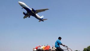 An IndiGo Airlines aircraft prepares to land as a man paddles his cycle rickshaw in Ahmedabad.(REUTERS) An IndiGo Airlines aircraft prepares to land as a man paddles his cycle rickshaw in Ahmedabad.(REUTERS)