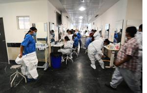 Staff take off or wear their personal protective suits: A cumbersome process that takes 45 minutes.(Ravi Kumar/HT photo) Staff take off or wear their personal protective suits: A cumbersome process that takes 45 minutes.(Ravi Kumar/HT photo)