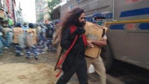 The man being taken away by the policeman. (Photo Sourced) The man being taken away by the policeman. (Photo Sourced)