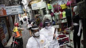 Health workers walk through the Rocinha slum to test people for Covid-19 in Rio de Janeiro, Brazil, Thursday, Oct. 8, 2020.(AP photo) Health workers walk through the Rocinha slum to test people for Covid-19 in Rio de Janeiro, Brazil, Thursday, Oct. 8, 2020.(AP photo)