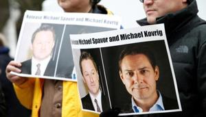 People hold signs calling for China to release Canadian detainees Michael Spavor and Michael Kovrig.(Reuters) People hold signs calling for China to release Canadian detainees Michael Spavor and Michael Kovrig.(Reuters)
