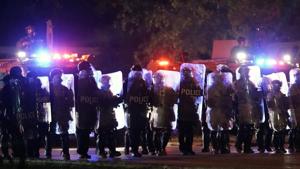 Police in riot gear line up in Wauwatosa, Wisconsin.(AP) Police in riot gear line up in Wauwatosa, Wisconsin.(AP)
