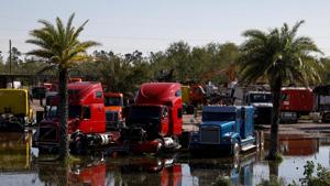 Trucks are seen in a flooded lot after Hurricane Delta, in Lake Charles, Louisiana, US(Reuters image)