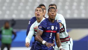 France's Presnel Kimpembe, right, and Portugal's Cristiano Ronaldo eye the ball during the UEFA Nations League soccer match between France and Portugal at the Stade de France in Saint-Denis, north of Paris, France.(AP) France's Presnel Kimpembe, right, and Portugal's Cristiano Ronaldo eye the ball during the UEFA Nations League soccer match between France and Portugal at the Stade de France in Saint-Denis, north of Paris, France.(AP)