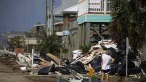 A person surveys damage to a neighbourhood after Hurricane Delta made landfall in Holly Beach, Louisiana on October 11.(Bloomberg) A person surveys damage to a neighbourhood after Hurricane Delta made landfall in Holly Beach, Louisiana on October 11.(Bloomberg)