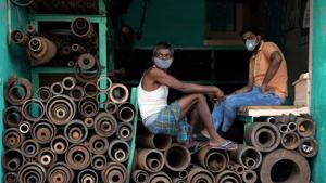 Workers wearing protective face masks sit inside a shop selling iron pipes at a wholesale iron market, after authorities eased lockdown restrictions that were imposed to slow the spread of the coronavirus disease (Covid-19), in Kolkata, India, June 15, 2020.(Reuters photo) Workers wearing protective face masks sit inside a shop selling iron pipes at a wholesale iron market, after authorities eased lockdown restrictions that were imposed to slow the spread of the coronavirus disease (Covid-19), in Kolkata, India, June 15, 2020.(Reuters photo)