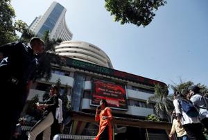 People walk past the Bombay Stock Exchange (BSE) building in Mumbai.(REUTERS) People walk past the Bombay Stock Exchange (BSE) building in Mumbai.(REUTERS)