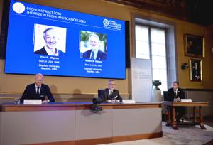 Americans Paul R. Milgrom, left on screen, and Robert B. Wilson have won the Nobel Prize in economics for "improvements to auction theory and inventions of new auction formats."(AP photo) Americans Paul R. Milgrom, left on screen, and Robert B. Wilson have won the Nobel Prize in economics for "improvements to auction theory and inventions of new auction formats."(AP photo)