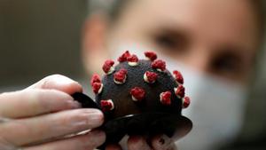 A confectioner arranges a cake shaped like a microscopic view of the coronavirus SARS-CoV-2 at a bakery, amid concerns about the spread of the disease in Prague, Czech Republic.(REUTERS) A confectioner arranges a cake shaped like a microscopic view of the coronavirus SARS-CoV-2 at a bakery, amid concerns about the spread of the disease in Prague, Czech Republic.(REUTERS)