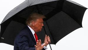 US President Donald Trump walks without a mask and carries an umbrella while boarding Air Force One as he departs Washington for travel to Florida, his first campaign trip since being treated for the coronavirus disease at Joint Base Andrews, Maryland.(REUTERS) US President Donald Trump walks without a mask and carries an umbrella while boarding Air Force One as he departs Washington for travel to Florida, his first campaign trip since being treated for the coronavirus disease at Joint Base Andrews, Maryland.(REUTERS)
