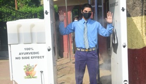 A school student passes through a sanitisation tunnel put up at St Joseph’s College in Prayagraj. (HT) A school student passes through a sanitisation tunnel put up at St Joseph’s College in Prayagraj. (HT)