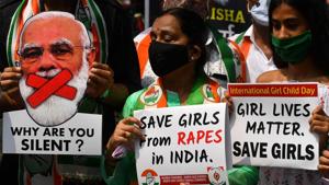 Political activists hold placards and a cut-out of India's Prime Minister Narendra Modi during a protest to condemn the alleged gang-rape and murder of a teenaged woman in Bool Garhi village at Hathras in Uttar Pradesh.(AFP) Political activists hold placards and a cut-out of India's Prime Minister Narendra Modi during a protest to condemn the alleged gang-rape and murder of a teenaged woman in Bool Garhi village at Hathras in Uttar Pradesh.(AFP)