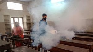 School staff members sanitize a classroom in Kozhikode in Kerala which is struggling with a surge in Covid-19 cases.(PTI)