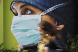 A woman walks in from of a mural painting of a nurse, in Milan, Italy, Wednesday. Coronavirus infections are surging again in the Italian northern region where the pandemic first took hold in Europe, putting pressure again on hospitals and health care workers.(AP file photo for representation) A woman walks in from of a mural painting of a nurse, in Milan, Italy, Wednesday. Coronavirus infections are surging again in the Italian northern region where the pandemic first took hold in Europe, putting pressure again on hospitals and health care workers.(AP file photo for representation)