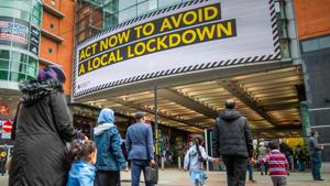 Pedestrians pass a large advertisement on the Arndale Centre shopping mall reading "Act now to avoid a local lockdown" in Manchester, UK, on Friday, Oct. 16, 2020.(Bloomberg) Pedestrians pass a large advertisement on the Arndale Centre shopping mall reading "Act now to avoid a local lockdown" in Manchester, UK, on Friday, Oct. 16, 2020.(Bloomberg)