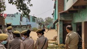 Police personnel stand guard as CBI officials (unseen) investigate the case of a 19-year-old Dalit woman who died after being allegedly gang-raped, in Hathras.(PTI) Police personnel stand guard as CBI officials (unseen) investigate the case of a 19-year-old Dalit woman who died after being allegedly gang-raped, in Hathras.(PTI)