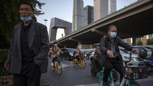 Commuters wearing face masks to protect against the coronavirus wait at an inteserction in the central business district in Beijing, Friday, Oct. 16, 2020. Authorities have completed tests on more than 10 million people in the northern Chinese port city of Qingdao after a hospital outbreak there blamed on "inappropriate disinfection."(AP) Commuters wearing face masks to protect against the coronavirus wait at an inteserction in the central business district in Beijing, Friday, Oct. 16, 2020. Authorities have completed tests on more than 10 million people in the northern Chinese port city of Qingdao after a hospital outbreak there blamed on "inappropriate disinfection."(AP)