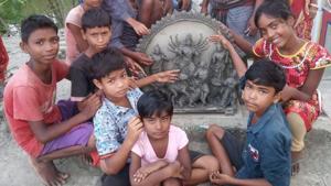 The idol is being made by Mondol and her friends at Bhandarjhali village, while another group of children in Mathurapur village in south Bengal is busy making the decorations with(HT PHOTO.) The idol is being made by Mondol and her friends at Bhandarjhali village, while another group of children in Mathurapur village in south Bengal is busy making the decorations with(HT PHOTO.)