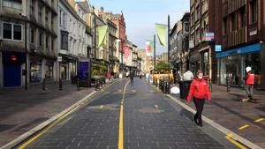 A person wears a face mask as they walk through the city centre as the coronavirus disease outbreak continues in Cardiff, Wales, on October 19.(Reuters) A person wears a face mask as they walk through the city centre as the coronavirus disease outbreak continues in Cardiff, Wales, on October 19.(Reuters)
