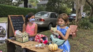 Maya Gebler and Cate Carroll read letters they've received from fairies in Norfolk, Va., on Monday Oct. 12, 2020. In the last few months, more than 700 letters have arrived at a fairy tree village outside the home of a journalist and children's book author.(AP) Maya Gebler and Cate Carroll read letters they've received from fairies in Norfolk, Va., on Monday Oct. 12, 2020. In the last few months, more than 700 letters have arrived at a fairy tree village outside the home of a journalist and children's book author.(AP)