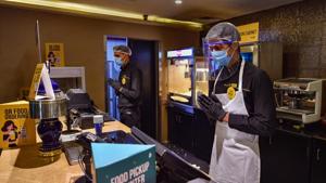 A worker at PVR cineplex is wearing face shield and mask as part of Covid-19 guidelines issued by the government.(PTI File Photo) A worker at PVR cineplex is wearing face shield and mask as part of Covid-19 guidelines issued by the government.(PTI File Photo)