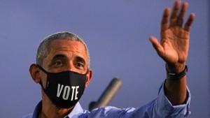 Former US president Barack Obama waves while wearing a Former US president Barack Obama waves while wearing a