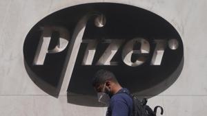 A man walks past a sign outside Pfizer Headquarters in the Manhattan borough of New York City.(REUTERS) A man walks past a sign outside Pfizer Headquarters in the Manhattan borough of New York City.(REUTERS)