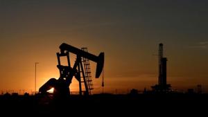 A pump jack operates in front of a drilling rig at sunset in an oil field in Midland, Texas US.(Reuters File Photo) A pump jack operates in front of a drilling rig at sunset in an oil field in Midland, Texas US.(Reuters File Photo)