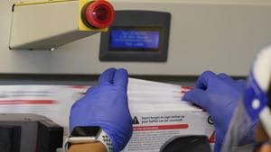 File photo - An election worker pulls a stack of returned ballots from a sorting machine at the King County Elections office in Renton, US.(AP) File photo - An election worker pulls a stack of returned ballots from a sorting machine at the King County Elections office in Renton, US.(AP)