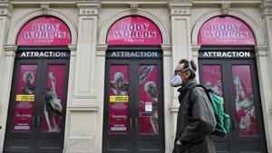 A pedestrian walks past shuttered outlets in London.(AFP/ FILE) A pedestrian walks past shuttered outlets in London.(AFP/ FILE)