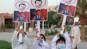 In picture - Kuwaiti youths lift placards expressing anger at French President Emmanuel Macron at a rally in front of the country's National Assembly (parliament) in Kuwait City.(AFP) In picture - Kuwaiti youths lift placards expressing anger at French President Emmanuel Macron at a rally in front of the country's National Assembly (parliament) in Kuwait City.(AFP)