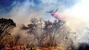 An air tanker drops retardant on the Olinda Fire burning in Anderson, California on Sunday.(AP Photo) An air tanker drops retardant on the Olinda Fire burning in Anderson, California on Sunday.(AP Photo)