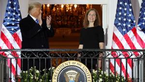 US President Donald Trump applauds US Supreme Court Associate Justice Amy Coney Barrett after she took her oath of office and was sworn in to serve on the court on the South Lawn of the White House in Washington.(REUTERS) US President Donald Trump applauds US Supreme Court Associate Justice Amy Coney Barrett after she took her oath of office and was sworn in to serve on the court on the South Lawn of the White House in Washington.(REUTERS)