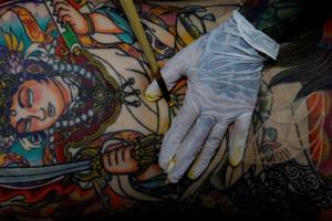 Tattoo artist Shodai Horiren, 52, tattoos her customer Rie Yoshihara at her studio in Warabi, Saitama Prefecture, Japan, September 4, 2020. "Your house gets old, your parents die, you break up with a lover, kids grow and go", said Horiren, "But a tattoo is with you until you're cremated and in your grave. That's the appeal." (REUTERS) Tattoo artist Shodai Horiren, 52, tattoos her customer Rie Yoshihara at her studio in Warabi, Saitama Prefecture, Japan, September 4, 2020. "Your house gets old, your parents die, you break up with a lover, kids grow and go", said Horiren, "But a tattoo is with you until you're cremated and in your grave. That's the appeal." (REUTERS)